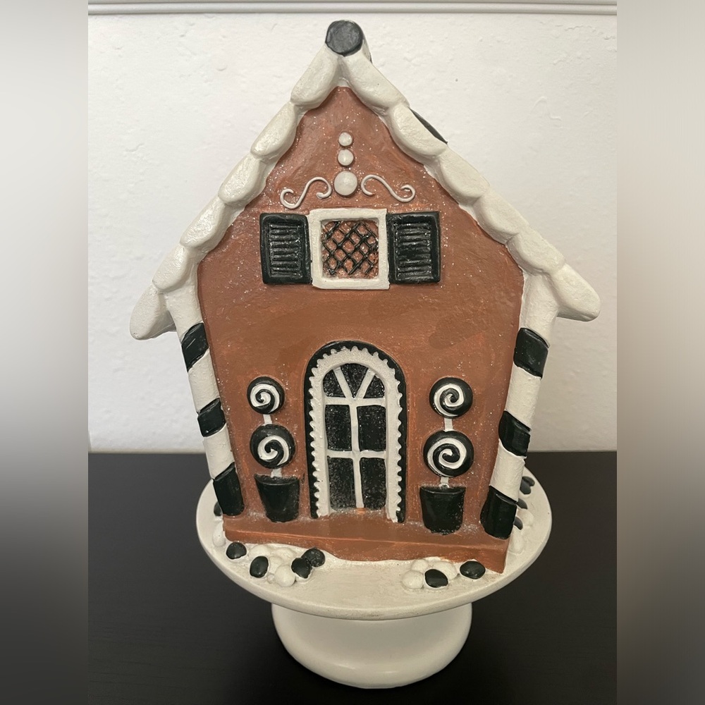 Vintage Ceramic Gingerbread House with white pedestal.